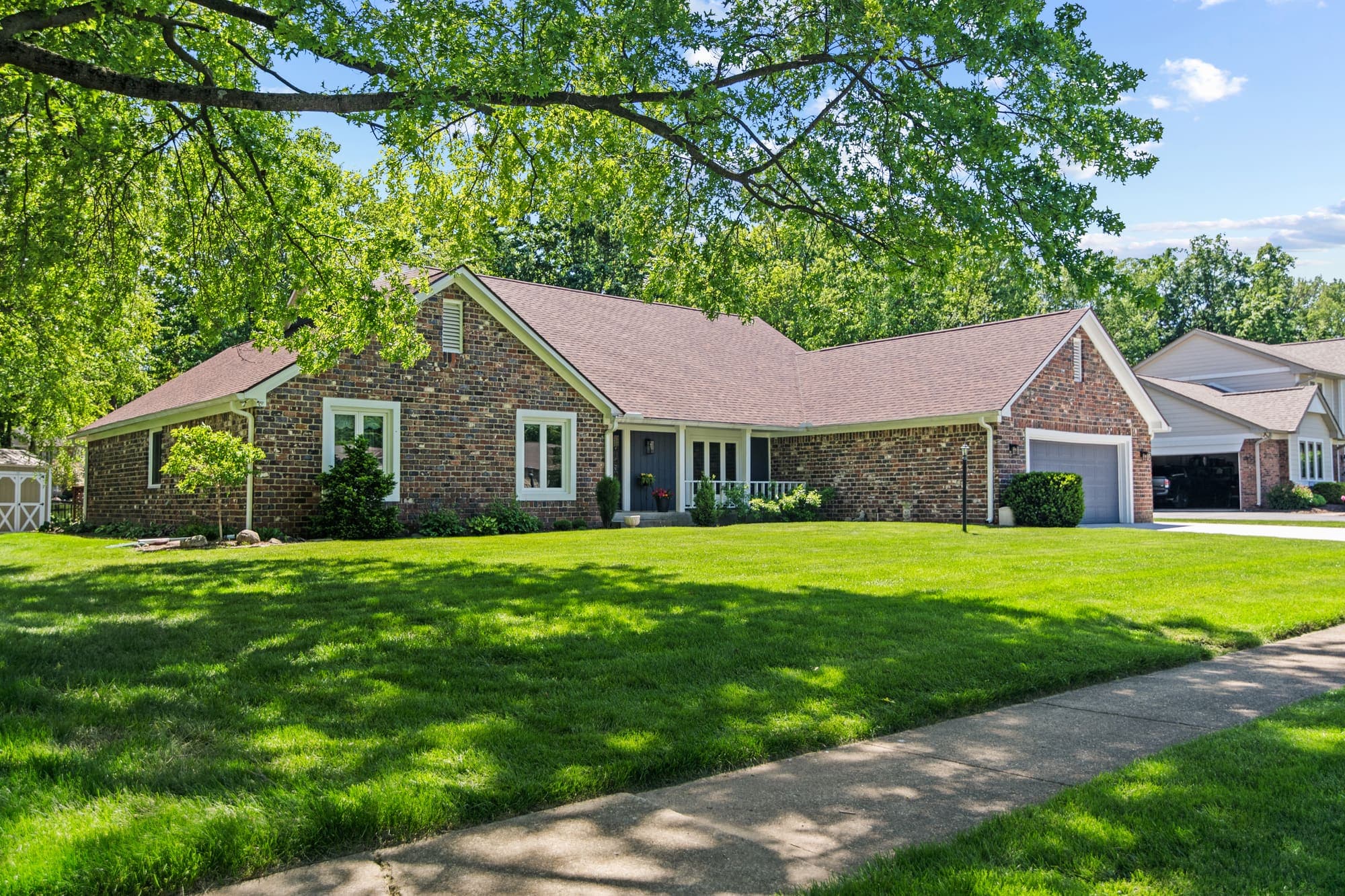 Brick ranch home on a large shaded lawn